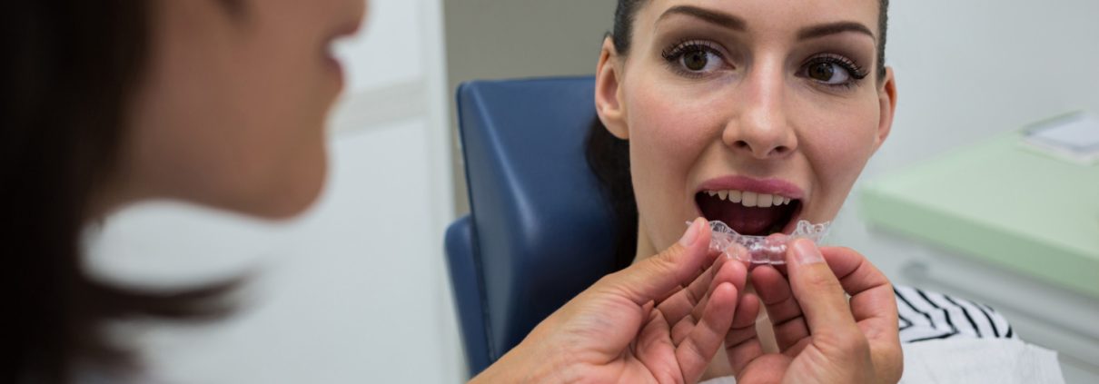 dentist-assisting-patient-wear-invisible-braces