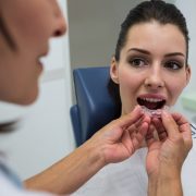 dentist-assisting-patient-wear-invisible-braces