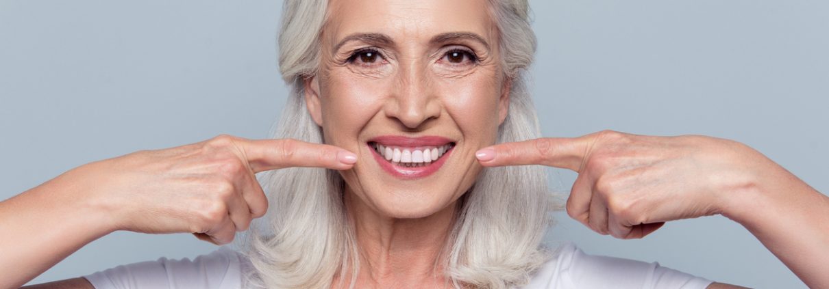 older woman smiling with dental implants