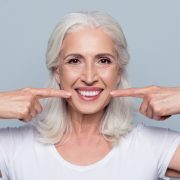 older woman smiling with dental implants