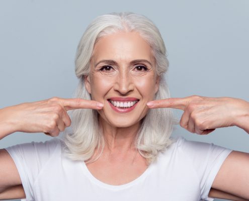 older woman smiling with dental implants